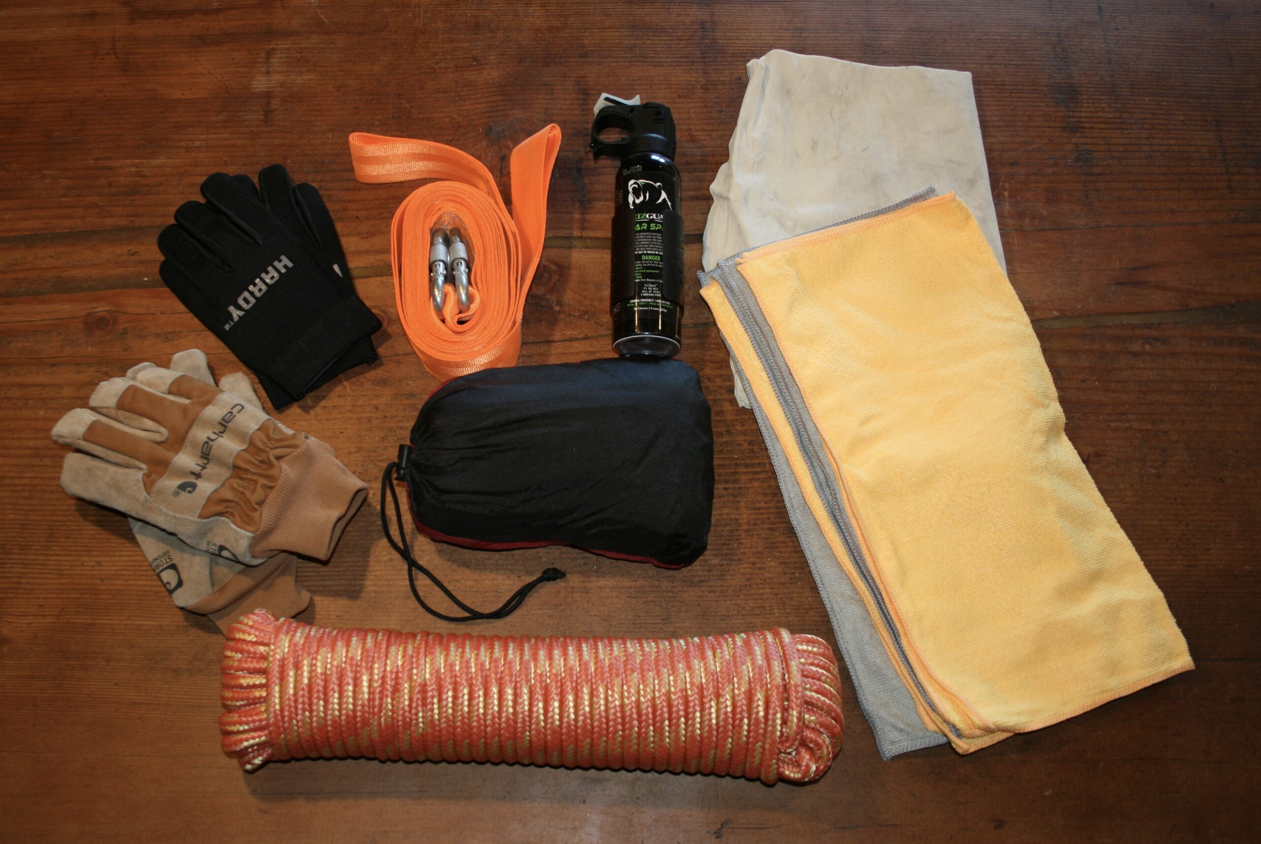 2018 Tacoma TRD Pro driver side under rear seat storage open showing gloves, shop rag, and jack