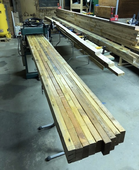 Boards running through the Grizzly G0453 planer — grey surface coming off, pale wood underneath