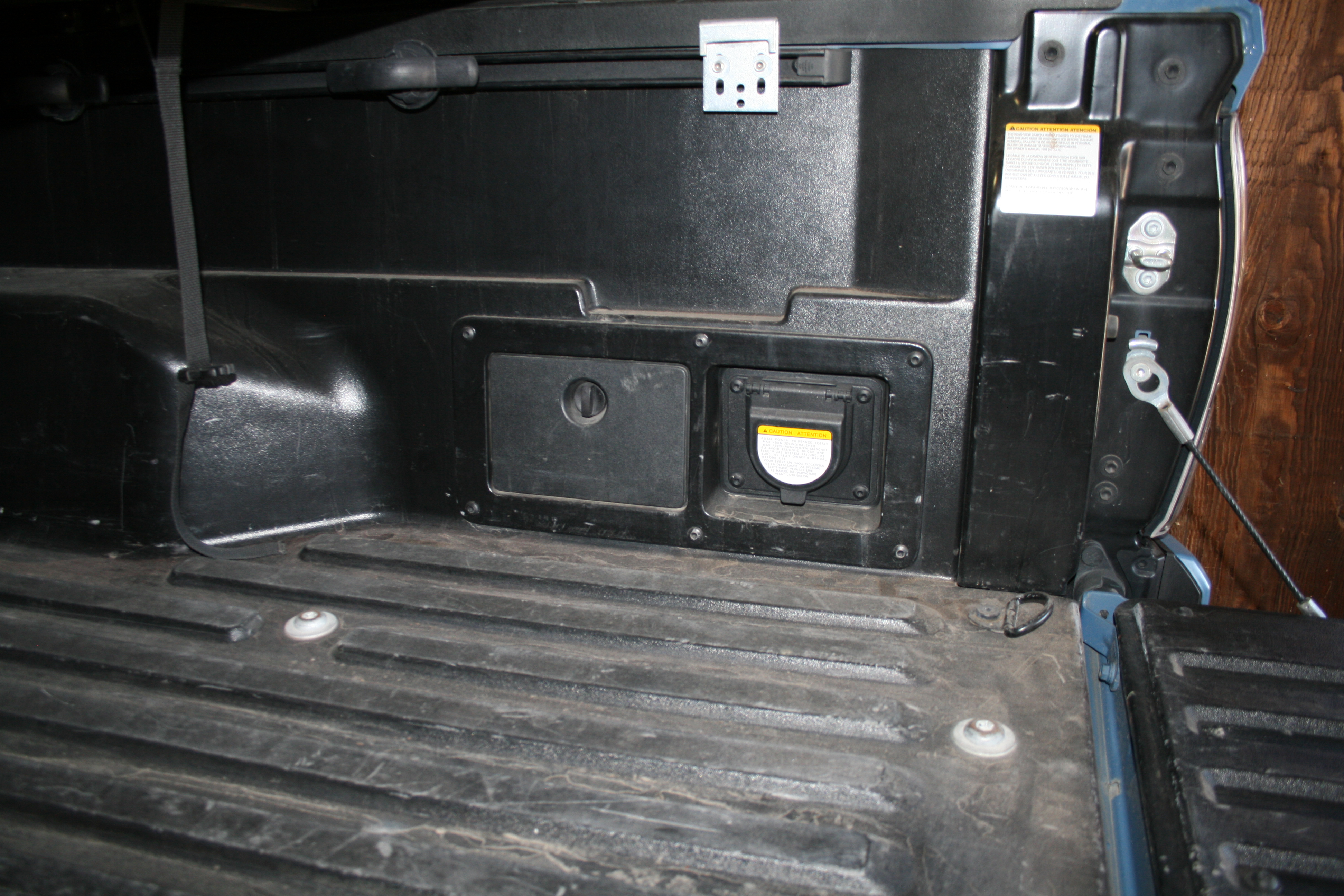 2018 Tacoma TRD Pro bed wall showing built-in storage compartment and 120V power outlet